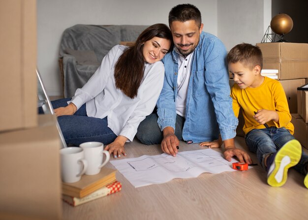 Full shot family ready to move into a new home