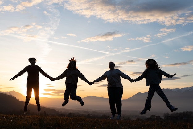 Full shot family silhouette in nature