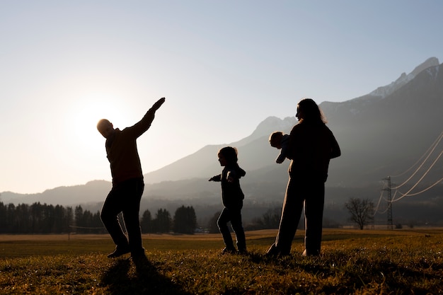 Full shot family silhouette in nature