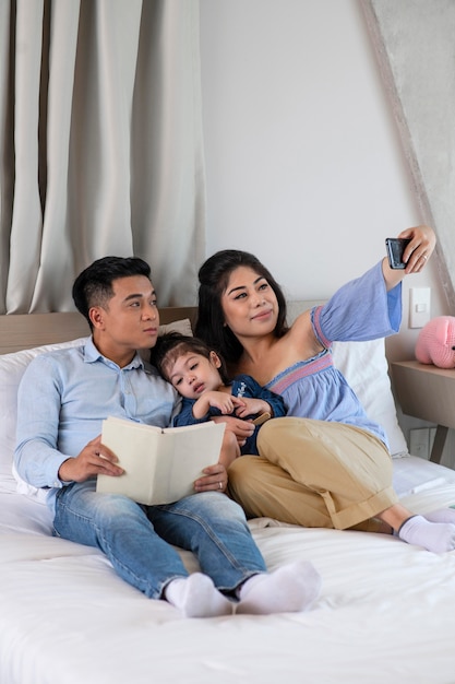 Full shot family taking selfie