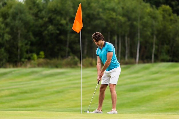 Full shot fit adult man playing golf