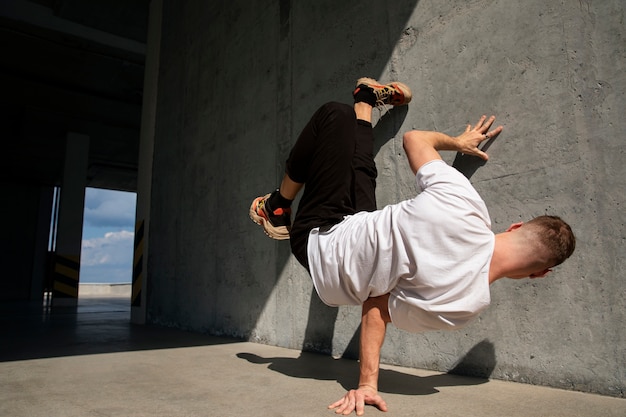 Free photo full shot fit man doing  parkour training