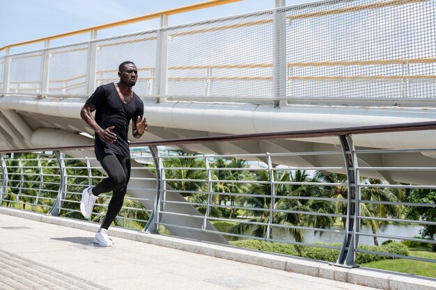 Full shot fit man running outdoors