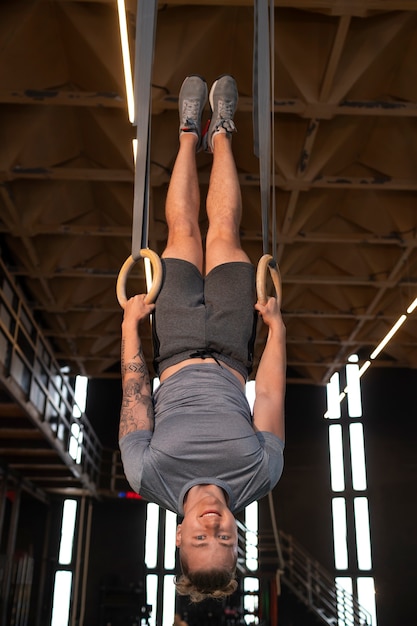 Full shot fit man working out at gym