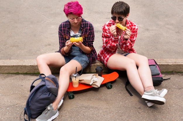 Free Photo full shot friends holding corn