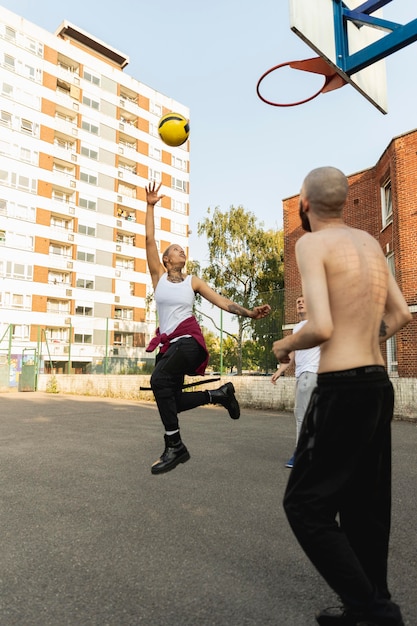 Free Photo full shot friends playing basketball