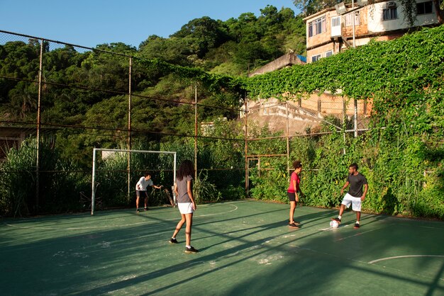 Full shot friends playing soccer