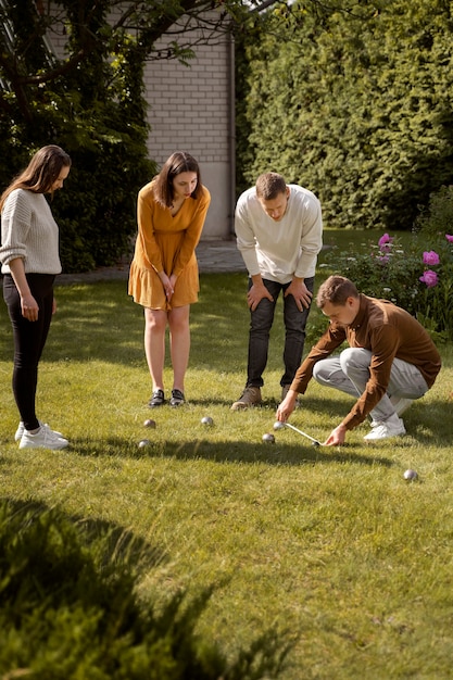 Free photo full shot friends playing sport outside