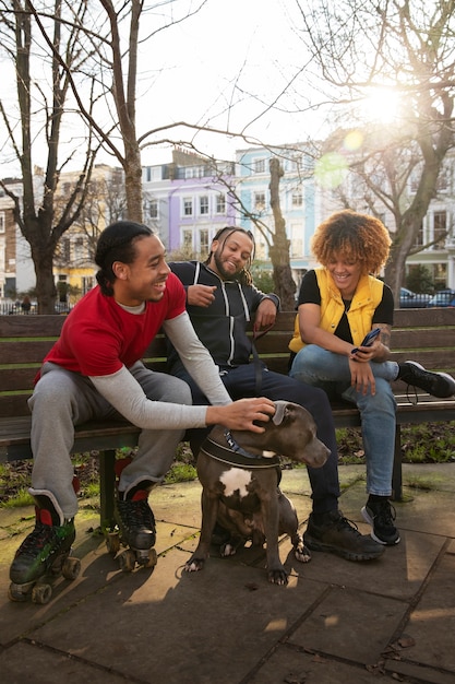 Free photo full shot friends sitting on bench