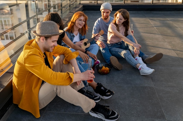 Free photo full shot friends sitting together