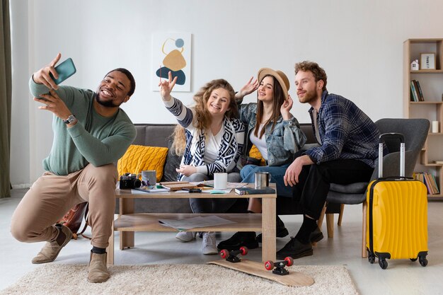 Full shot friends taking selfie