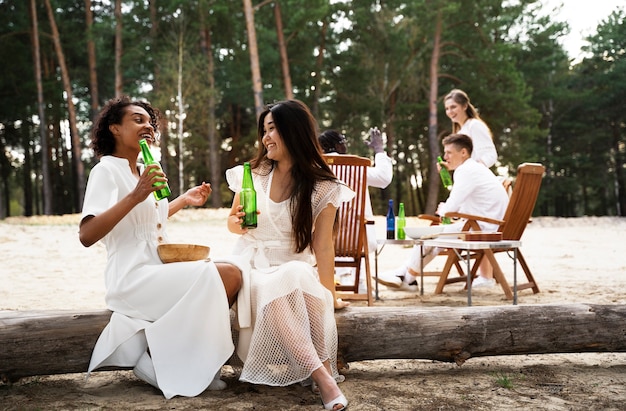 Full shot friends wearing white clothes