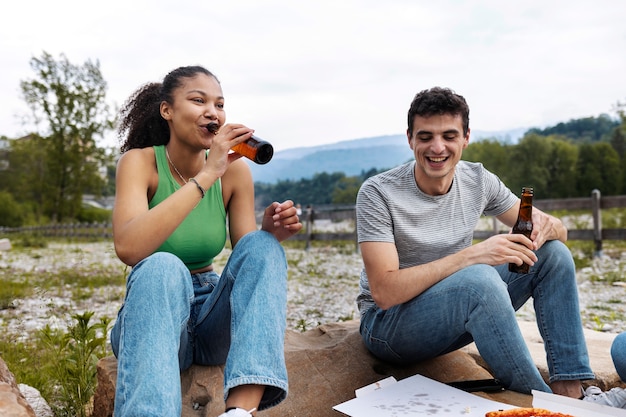 Full shot friends with drinks outdoors