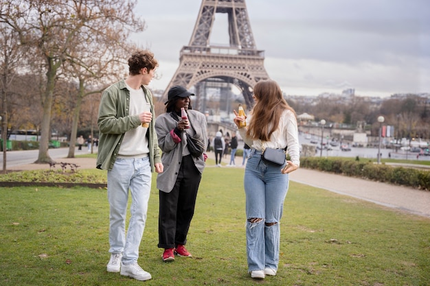 Full shot friends with drinks in paris