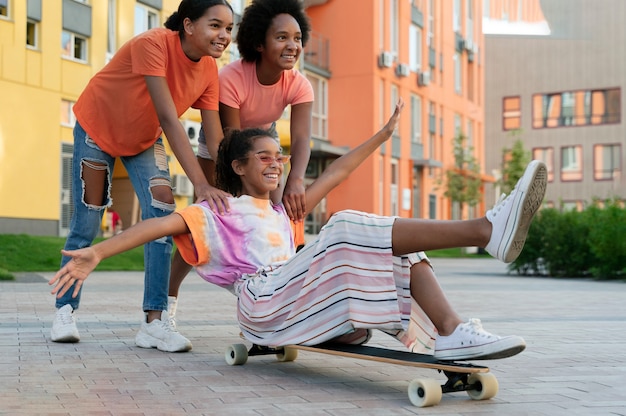 Full shot friends with skateboard