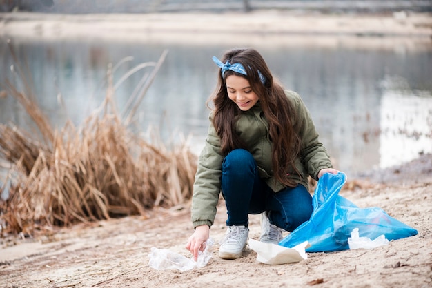 Full shot of girl cleaning the ground