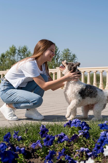 Full shot girl and cute dog outdoors