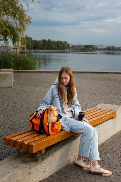 Full shot girl and dog on bench