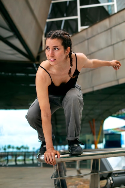 Full shot girl doing parkour training