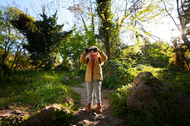 Free photo full shot girl exploring nature