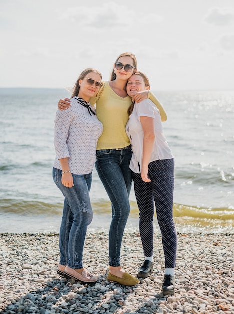 Full shot girl friends at the seaside