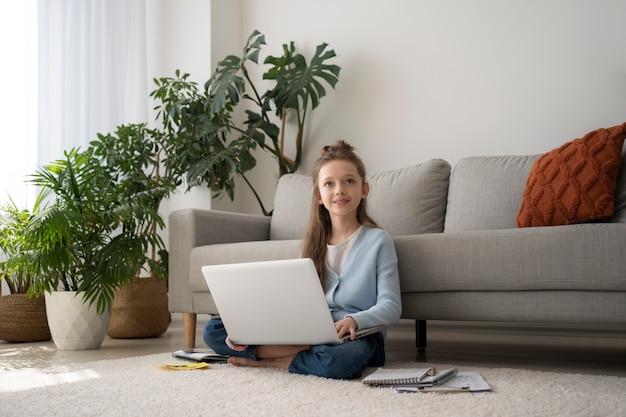 Full shot girl holding laptop