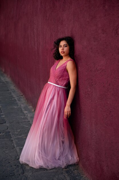 Full shot girl posing in pink dress