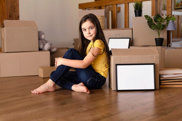 Full shot girl posing with box