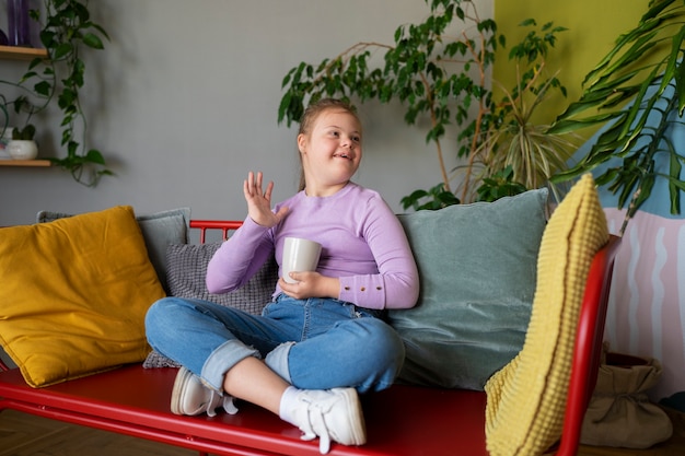 Free Photo full shot girl sitting indoors