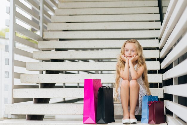 Full shot girl sitting on the stairs