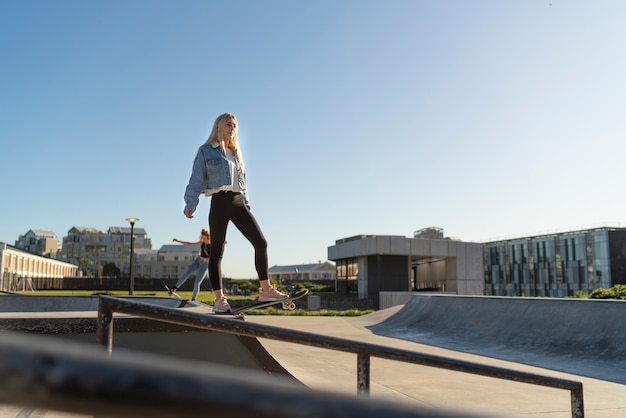 Full shot girl on skateboard outdoors