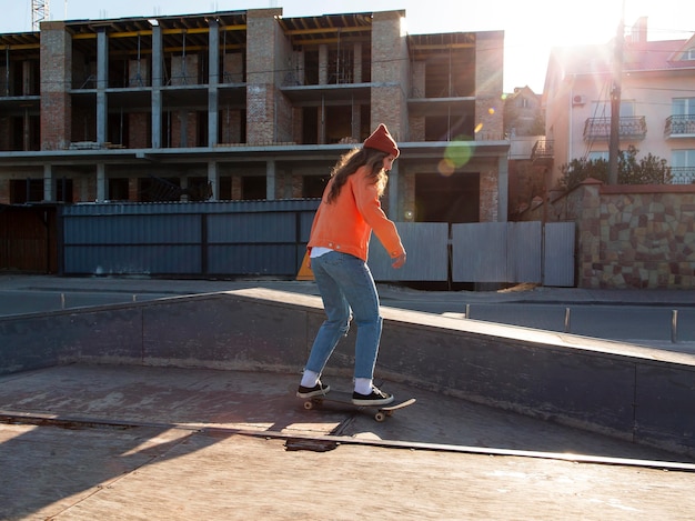 Full shot girl skating outdoors