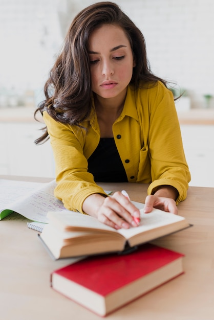 Full shot girl studying indoors