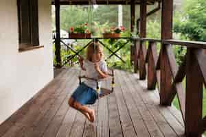 Free photo full shot girl on swing