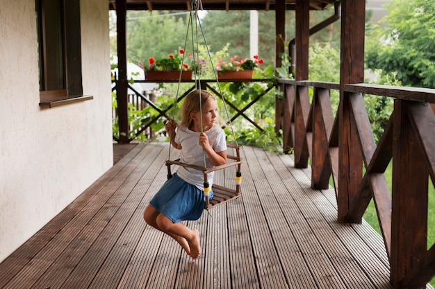 Free Photo full shot girl on swing