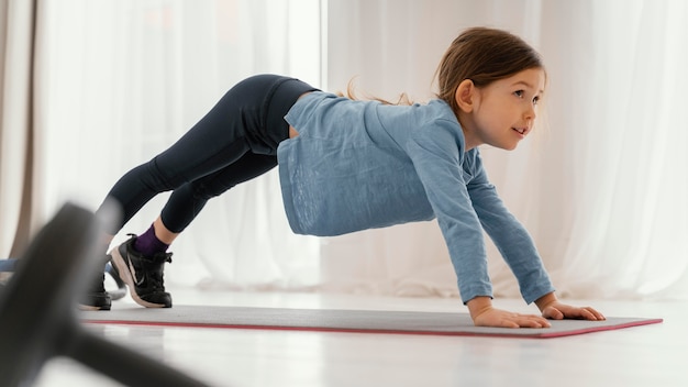 Full shot girl training on mat