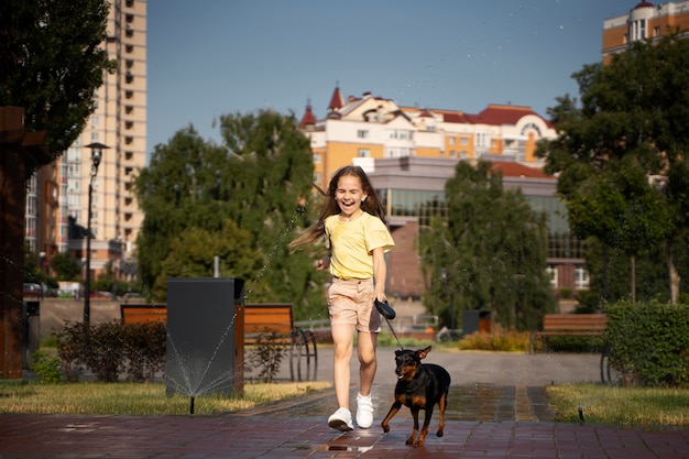 Full shot girl walking dog