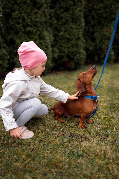 Full shot girl with cute dog outdoors