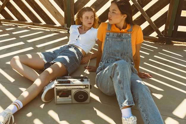 Full shot girls with cassette player