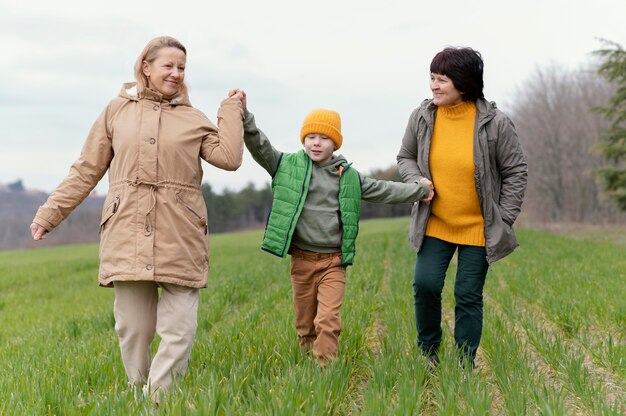 Full shot grandmothers holding kid