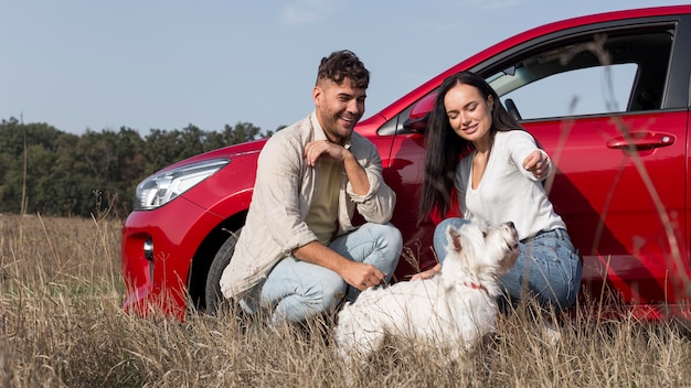 Full shot happy couple with dog