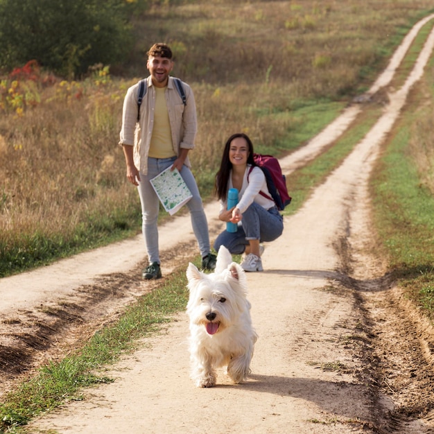 Full shot happy couple with dog