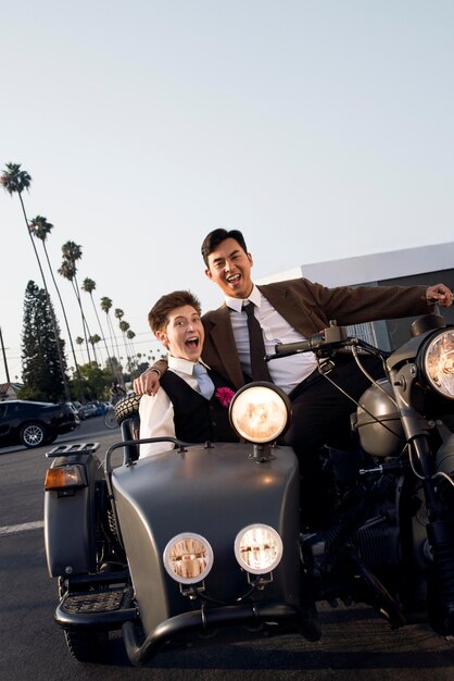 Full shot happy couple with motorcycle