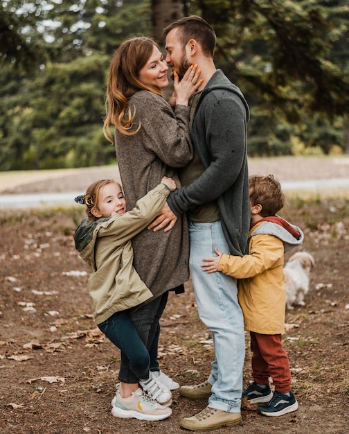 Free photo full shot happy family hugging