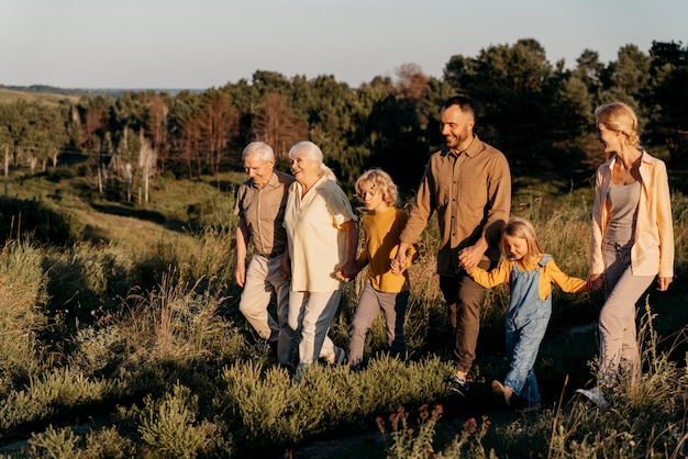 Free photo full shot happy family in nature