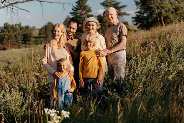 Free photo full shot happy family outdoors