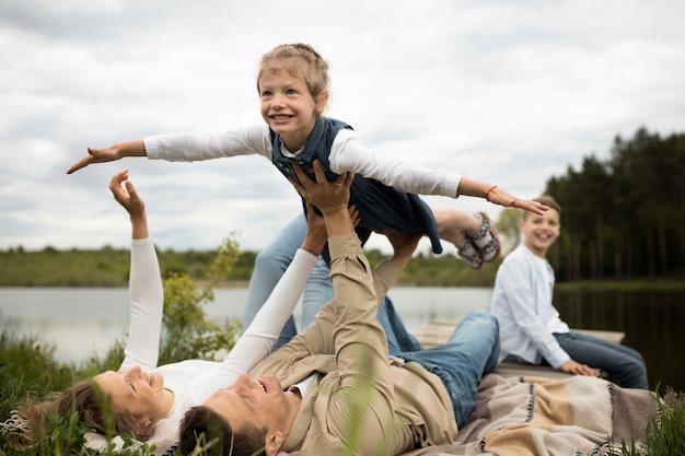 Free photo full shot happy family spending time in nature