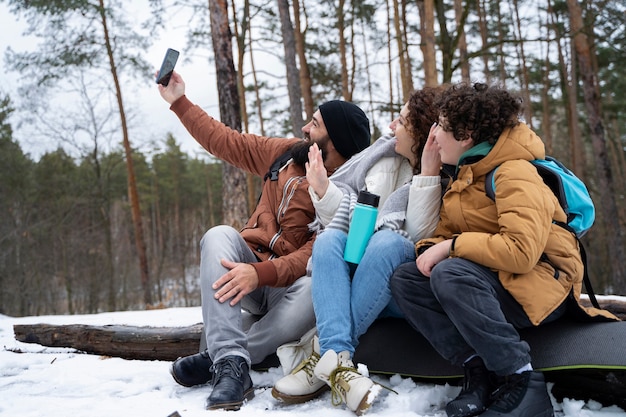 Free Photo full shot happy family taking selfie