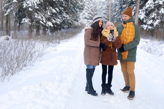 Full shot happy family winter time