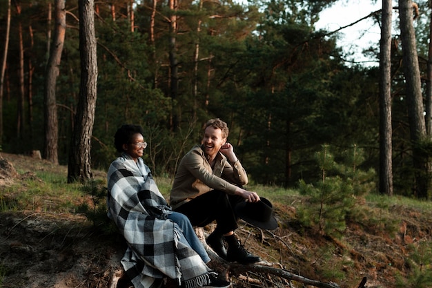 Free photo full shot happy friends in forest